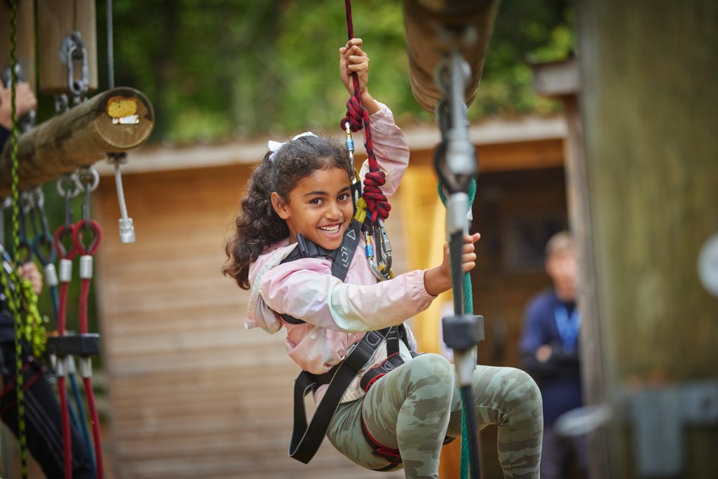 Child hanging from harness at PGL Little Canada