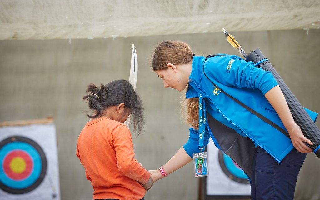 PGL Activity Instructor teaching child Archery
