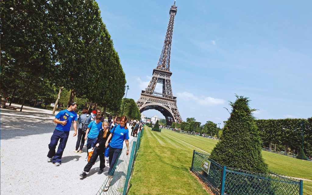 PGL Tour Leaders leading group away from the Eiffel Tower