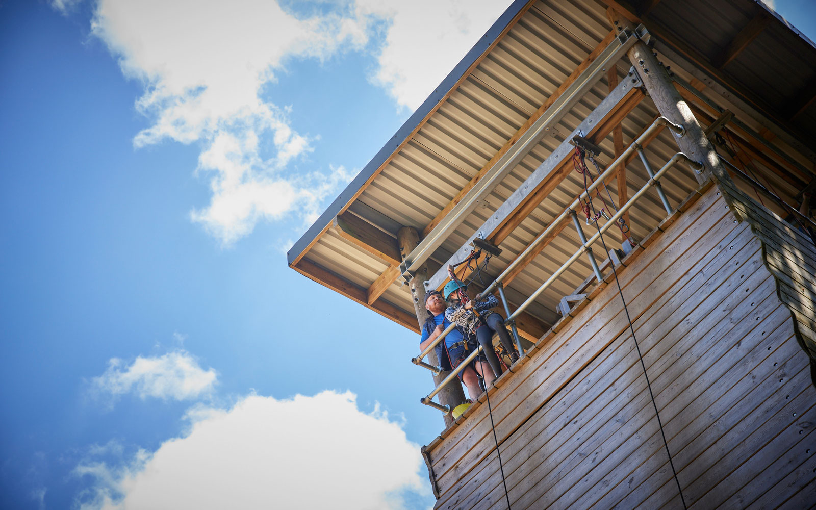 Activity Instructor and child at the top of an Abseil tower