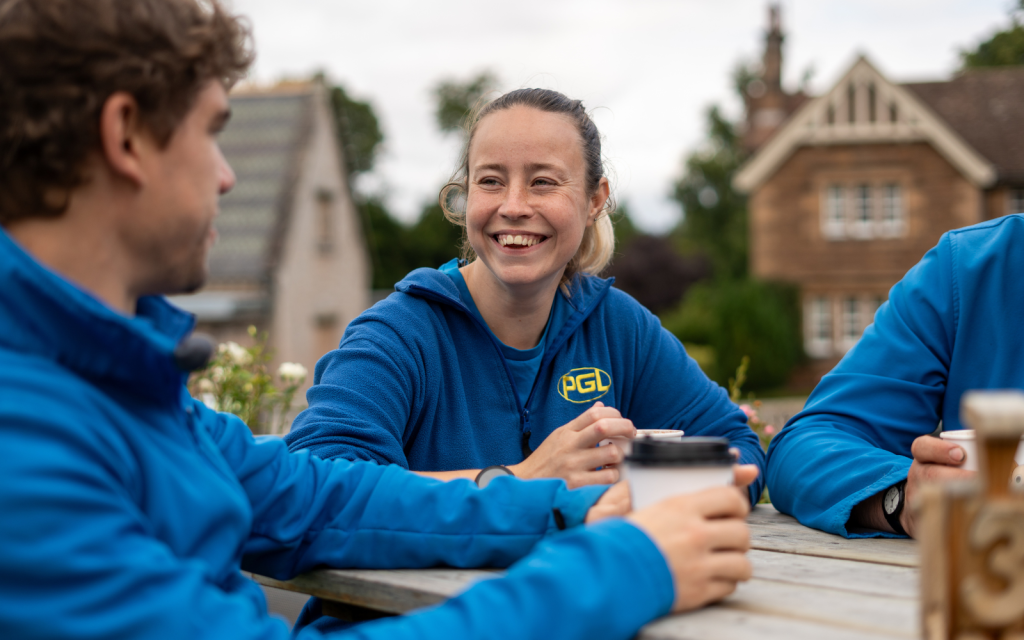 PGL colleagues smiling around table
