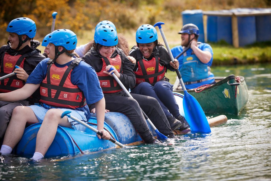 A laughing group of teenagers on a raft