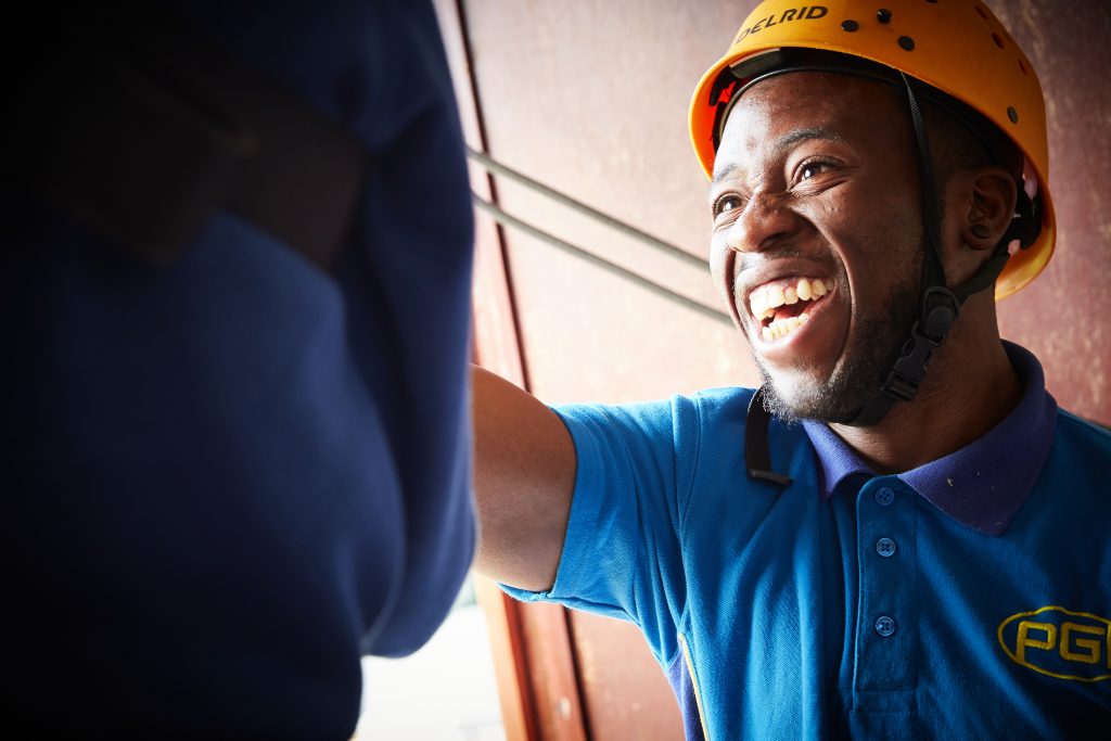 Smiling activity instructor at a PGL activity centre