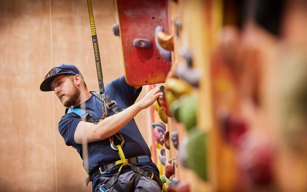 AIGL Team Leader seen climbing a wall